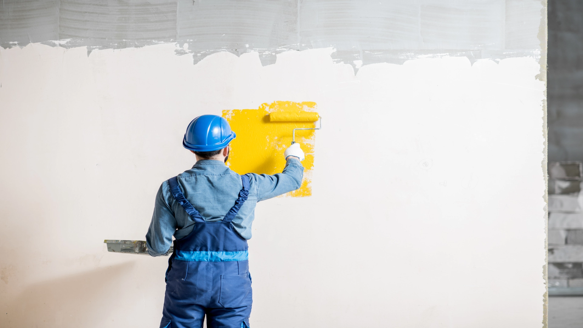 workman painting wall indoor